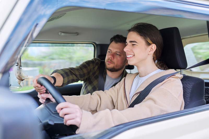 father-teaching-his-teenage-son-to-drive-2022-03-09-22-02-11-utc