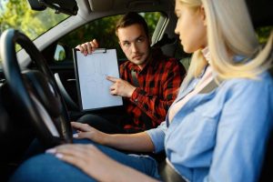 woman-and-man-with-checklist-driving-school-2021-08-28-20-00-42-utc